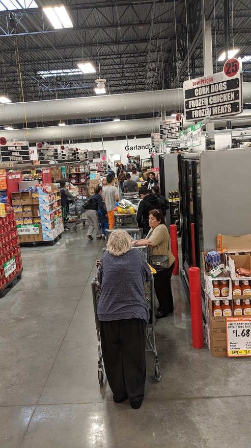 A line of grocery carts stretching from the back of the store to the front